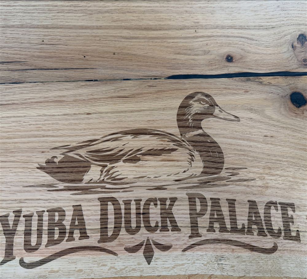 Oak board engraved with a mallard duck above the words Yuba Duck Palace