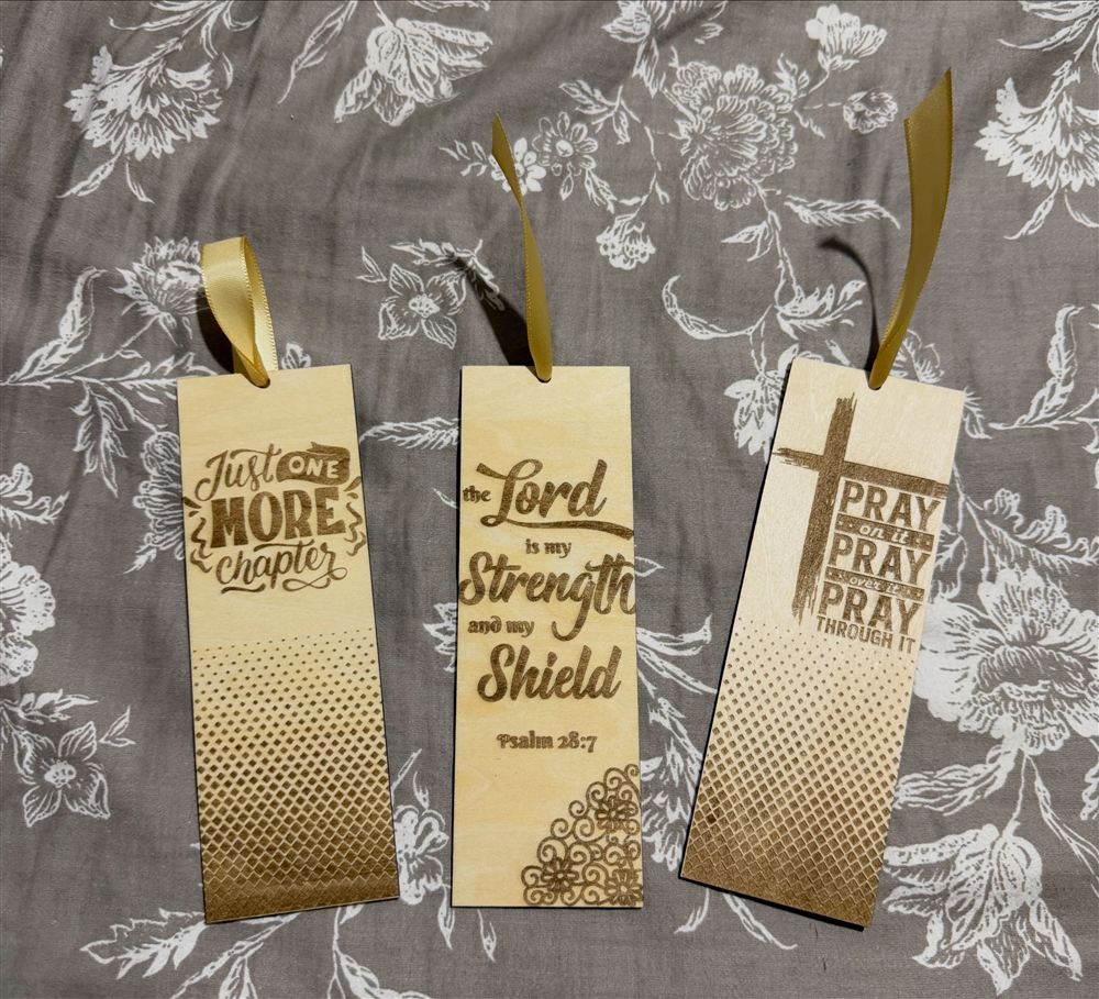 Three engraved bookmarks with gold ribbons and scripture sayings
